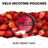 VELO Ruby Berry 14mg nicotine pouch can on fresh ripe strawberries